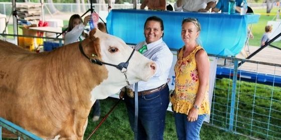 Kayla and Karin with a prize winning beef at FFA show