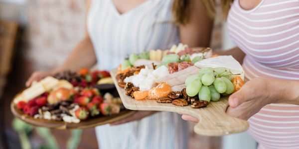 galentines day women holding charcuterie trays for Galentine's Day